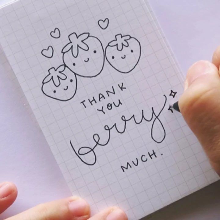 someone is writing on a notepad with two strawberries and the words thank you very much