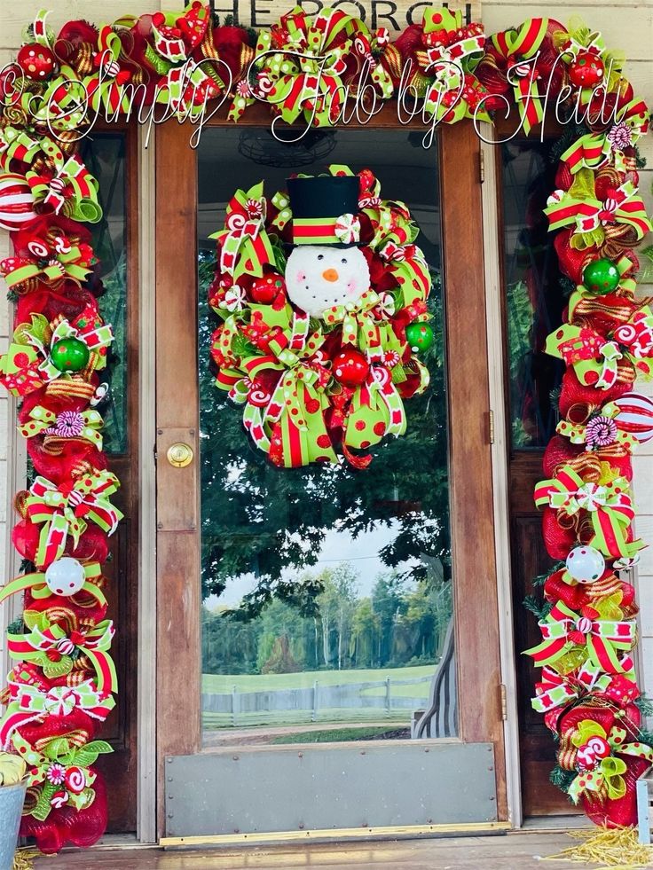 a christmas wreath on the front door of a house with santa's hat and candy canes