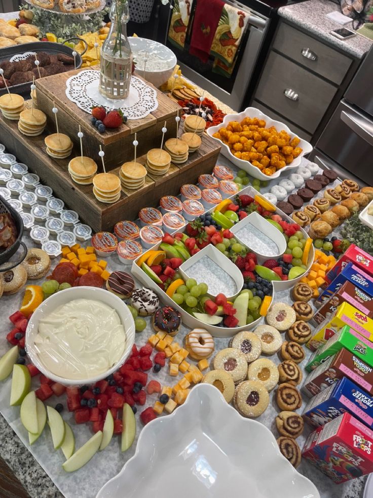 a table filled with lots of food and desserts