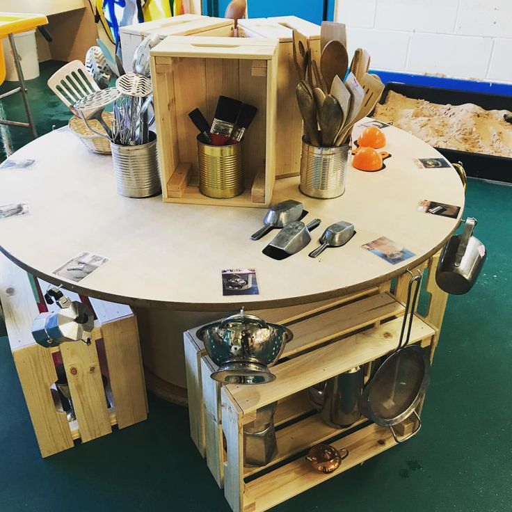 a kitchen table made out of wood with pots and pans on it