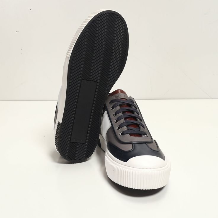 This leather lace up sneaker has been handcrafted from flawless grain leather, embellished with a leather insole that nods to the brand's heritage. Perfectly paired with tailored suits and leather jackets. Leather Lining for a luxurious feel and moisture control Leather collar and tongue Rubber sole Tapered round toe. The handmade sustainable Gommus rubber outsole and insole are Made in Italy. STYLE #D2168T Navy Leather Sneakers With Leather Sole, Sporty Navy Sneakers With Stitched Sole, Navy Leather Low-top Custom Sneakers, Classic Navy Sneakers With Contrast Sole, Navy Leather Sneakers With Round Toe, Navy Leather Sneakers For Streetwear, Low-top Calf Leather Lace-up Shoes For Derby, Low-top Calf Leather Lace-up Shoes With Stitched Sole, Low-top Lace-up Shoes With Stitched Sole In Calf Leather