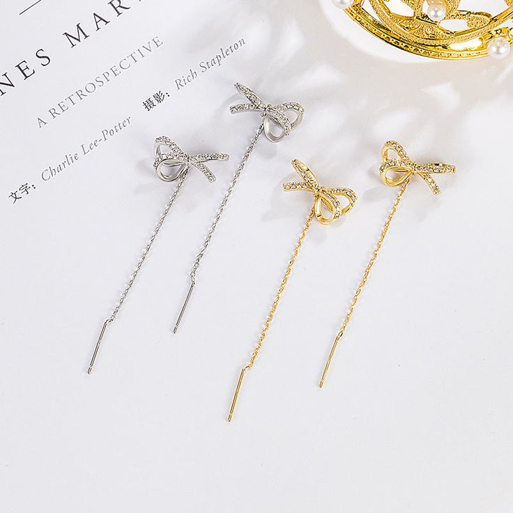 ✦ Unveil a new level of sophistication with our 925 Sterling Silver Bow Dangle Earrings, a masterpiece of design. These Tassel Earrings redefine uniqueness with their striking blend of classic charm and contemporary flair. The silver bows elegantly transition into flowing tassels, making a bold and artistic statement. Whether you're celebrating a special moment or expressing your daily style, these earrings are a unique choice for those who appreciate the extraordinary in their accessories. ---- Tassel Drop Earrings As Gift, Elegant Single Earring As Gift, Silver Dangle Threader Earrings For Party, Silver Sterling Threader Earrings For Party, Silver Sterling Silver Threader Earrings For Party, Sterling Silver Linear Earrings For Party, Luxury Drop Earrings For Gift, Silver Dainty Jewelry For Evening, Elegant Single Silver Earring