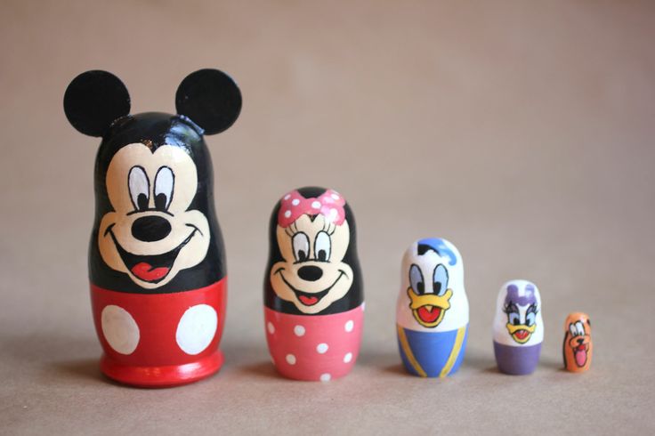 a group of mickey and minnie mouse figurines sitting next to each other