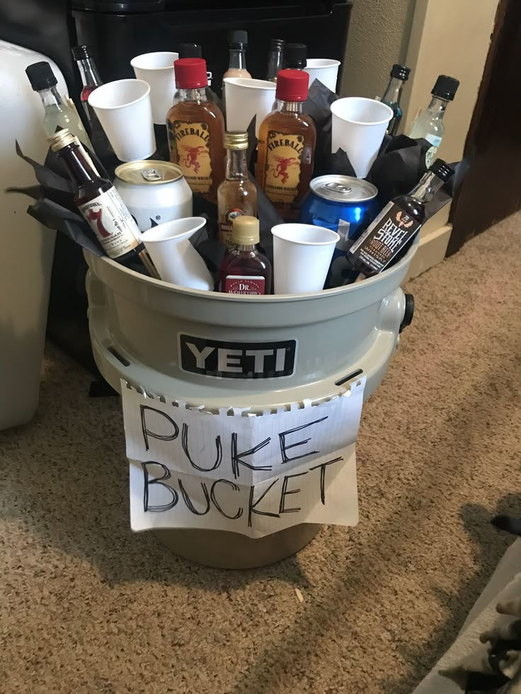 a bucket filled with liquor bottles sitting on top of a carpeted floor