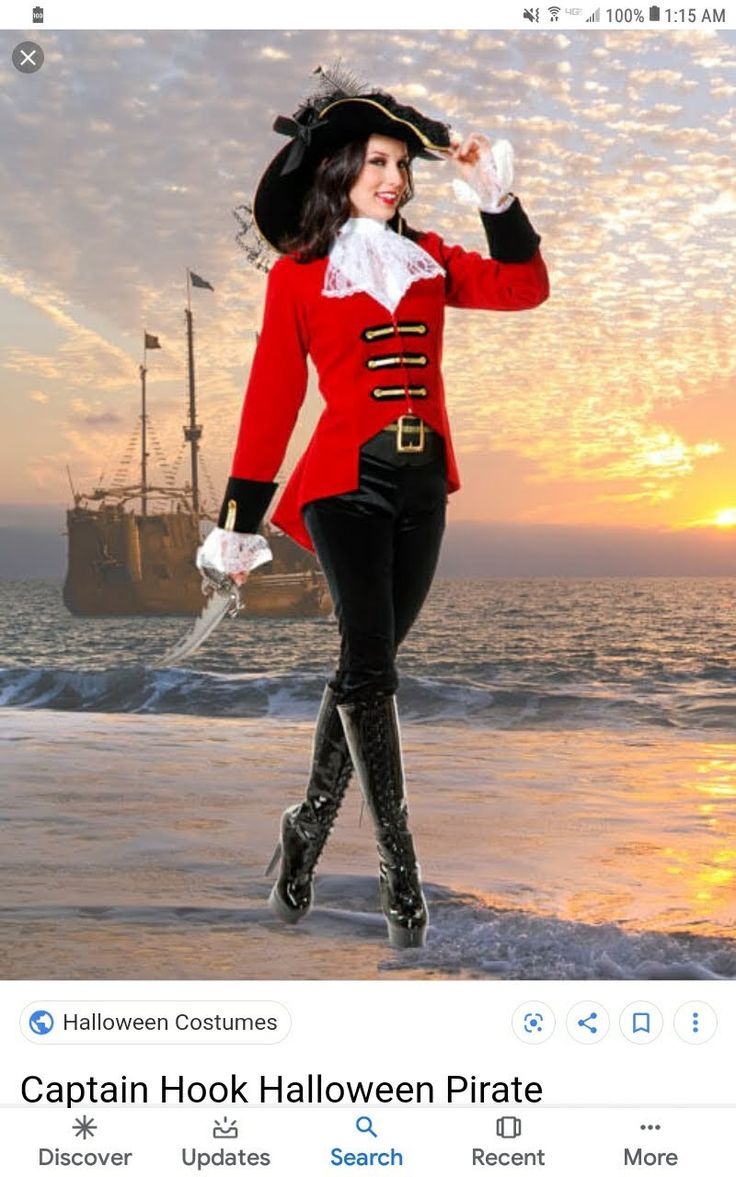 a woman dressed as captain hook in front of the ocean with a pirate ship behind her