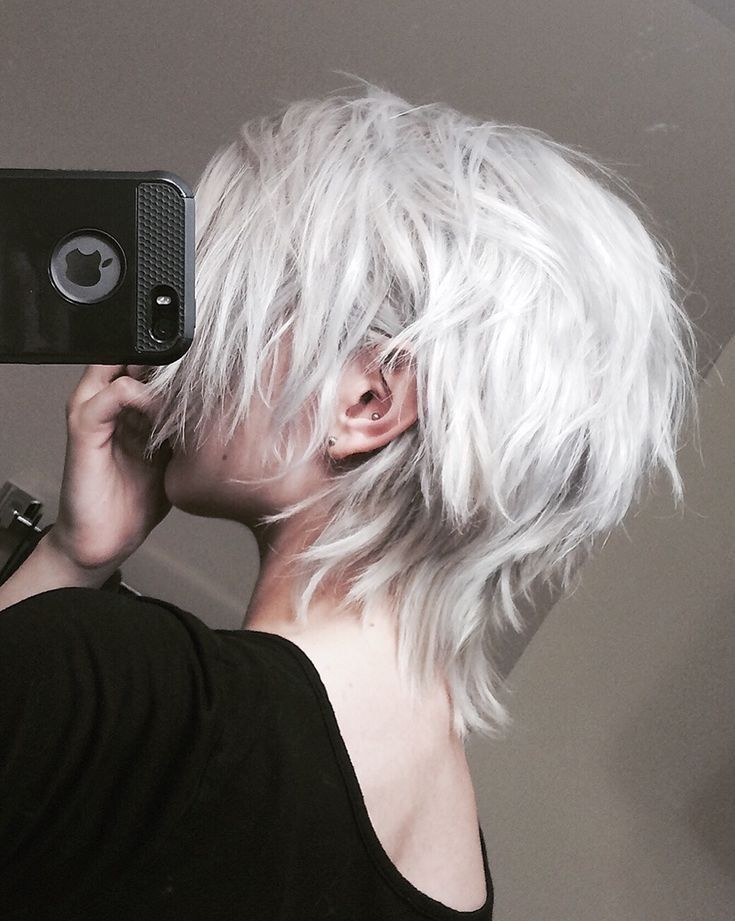 a woman with white hair is taking a selfie in front of a mirror while holding her cell phone up to her ear