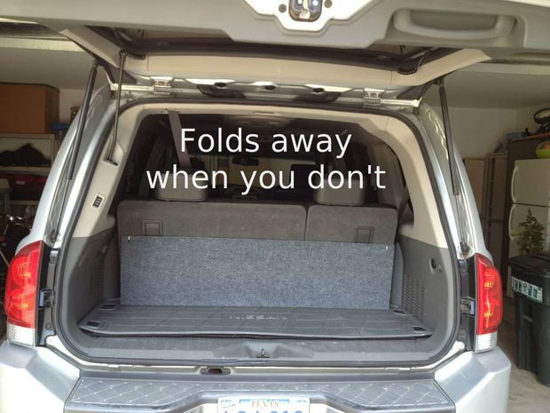 the back end of a silver van with an open trunk