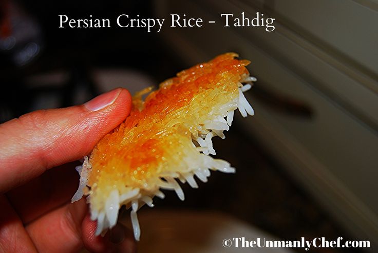 a person holding a piece of food in their hand with the caption persian crispy rice - taldig