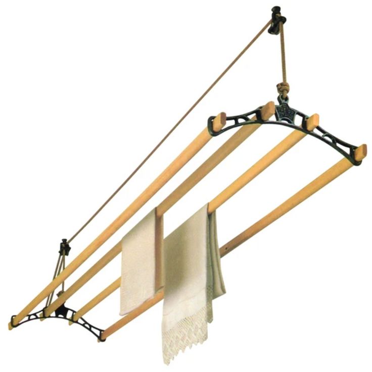 a pair of wooden clothes racks hanging from the side of a wall with two white towels on them