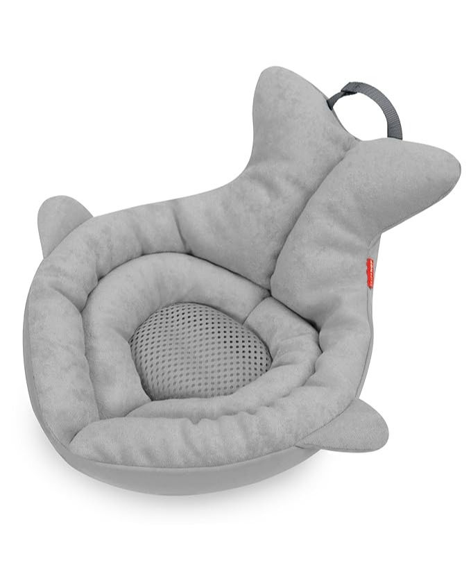 a grey dog bed with a cat in it's mouth and a red tag on the collar