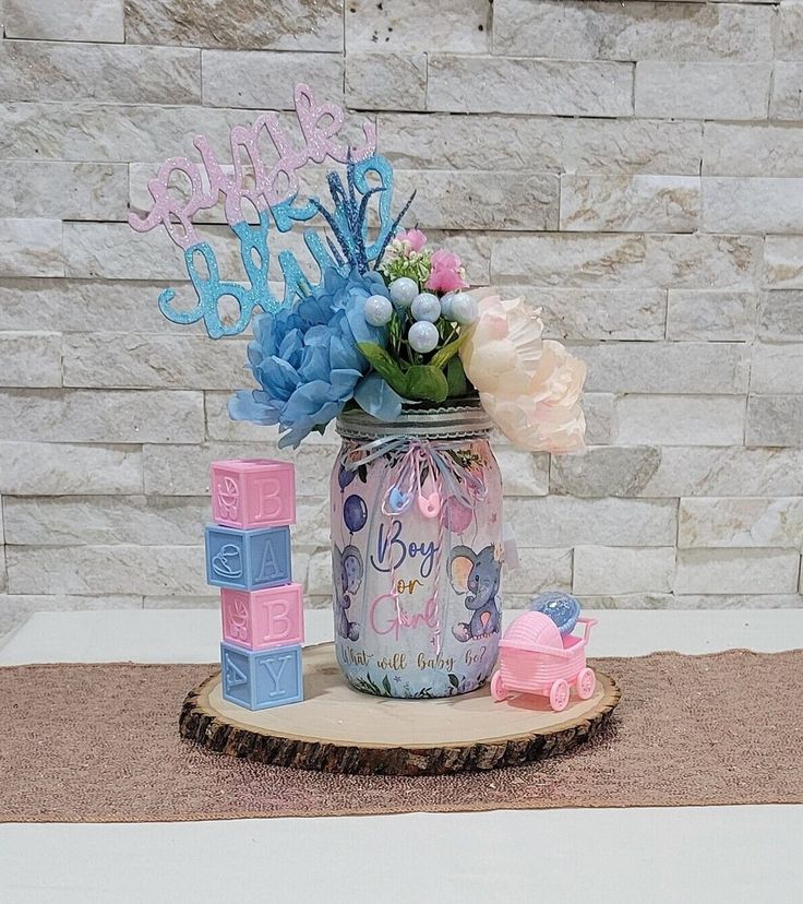 a birthday cake in a jar with flowers and blocks