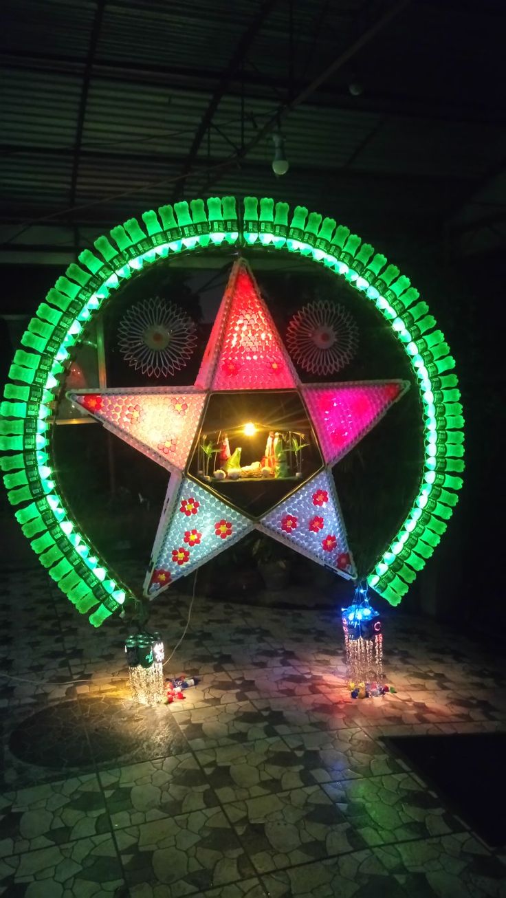 the large star is lit up with colorful lights