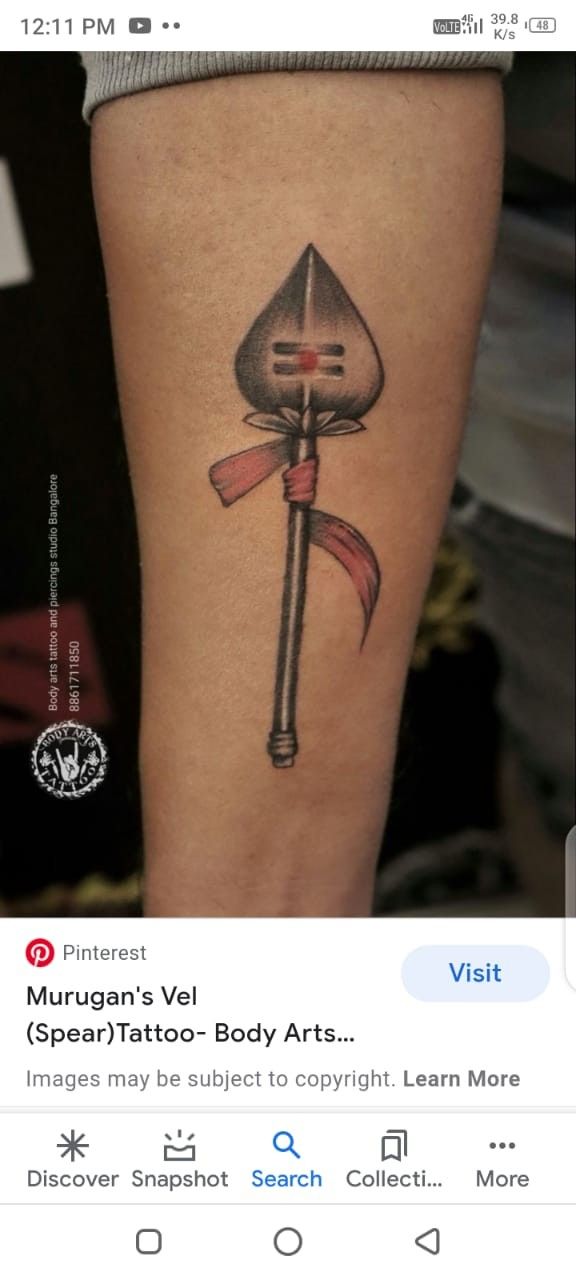 a tattoo on the leg of a woman with an image of a hammer and sick knife