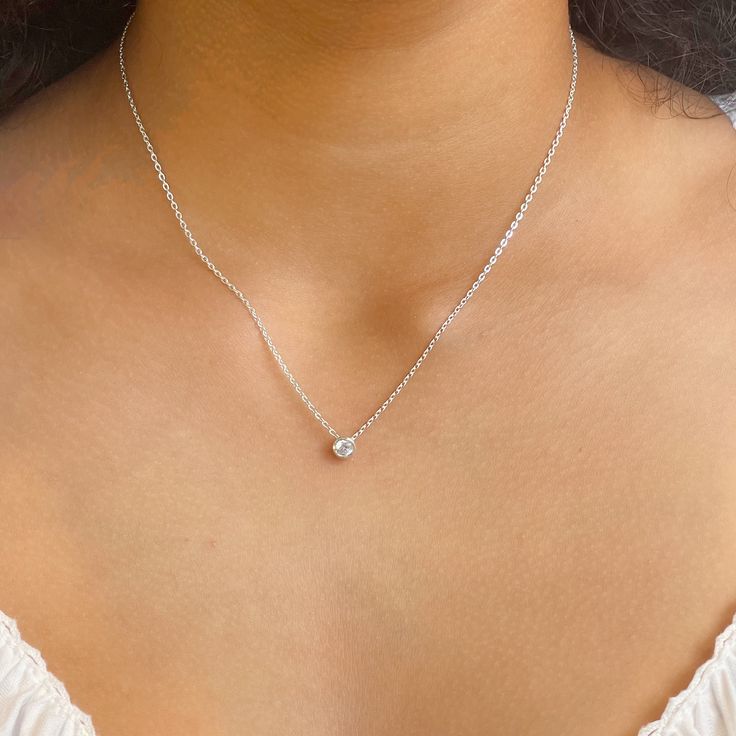 Our bezel solitaire necklace is available in sterling silver or 14KT gold vermeil. Materials: 925 sterling silver or 14KT gold vermeil Vermeil: 14KT yellow gold plating over 925 sterling silver Gemstone: Cubic Zirconia Closure: Spring ring Length: Adjustable length 16" to 18" Follow us on Instagram @pennyweightsjewelry Follow us on Facebook @facebook.com/pennyweights Follow us on Pinterest @pennyweights Click on the links at the bottom left of this page! Diamond White Sterling Silver Solitaire Necklace With Round Pendant, Minimalist Silver Diamond Necklace With Birthstone, Classic Silver Diamond Necklace With Birthstone, Diamond White Solitaire Necklace With Round Sterling Silver Pendant, Silver Minimalist Diamond Birthstone Necklace, Everyday Round Solitaire Necklace With Bezel Setting, Cubic Zirconia Solitaire Necklace With Round Stone, Dainty White Gold Solitaire Necklace With Bezel Setting, Round Cubic Zirconia Solitaire Necklace