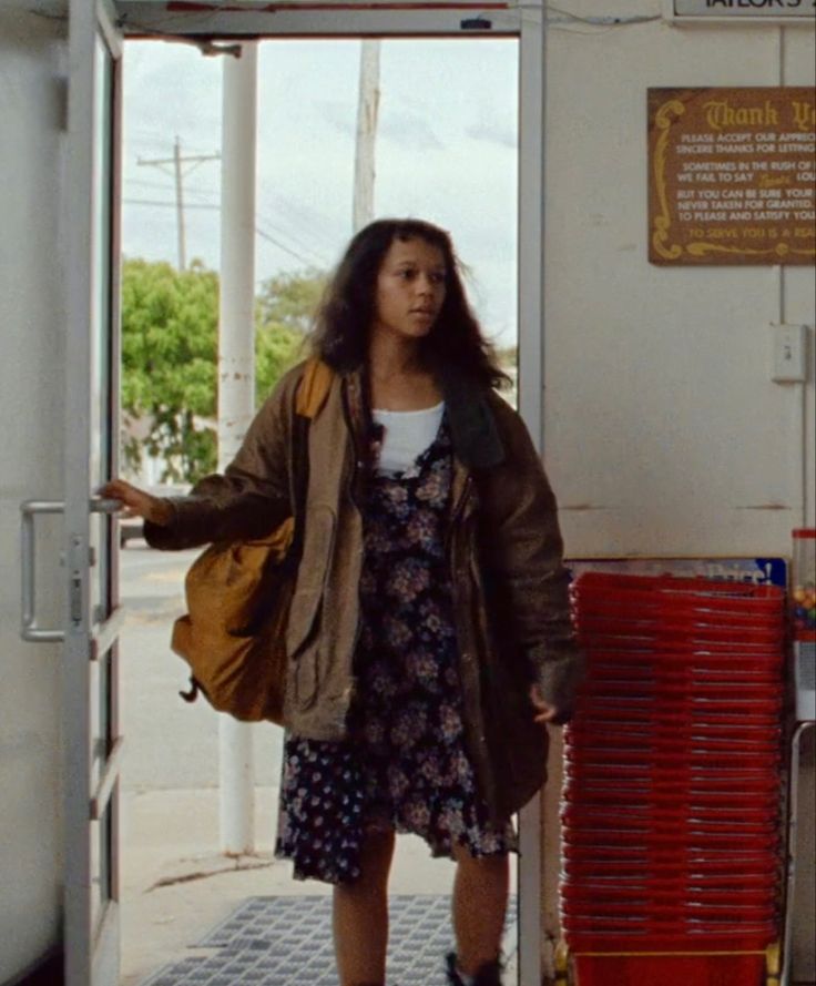 a woman standing in the doorway of a building