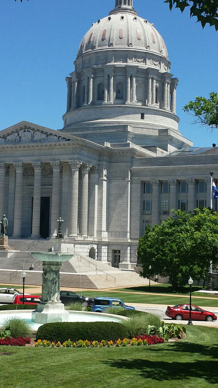 the state capitol building in washington, d c is seen from across the street with cars parked nearby