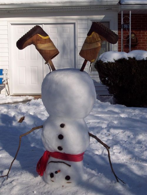 a snowman with two skis on his head