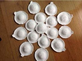 a bunch of white bowls sitting on top of a wooden table