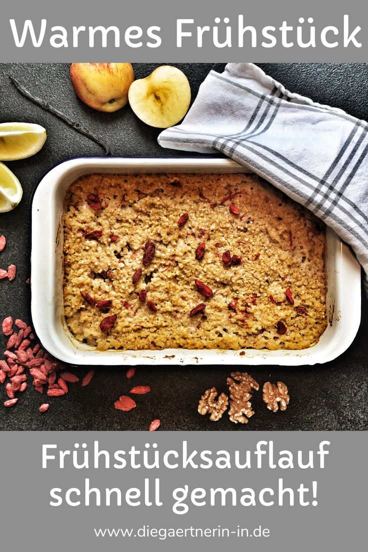 a close up of a casserole in a pan with fruit on the side