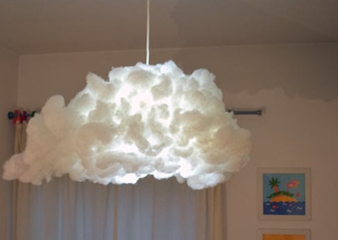 a large white cloud light hanging from a ceiling