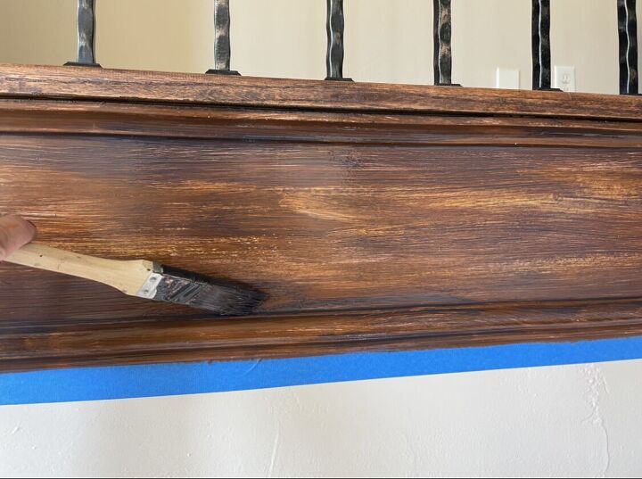 a paintbrush is being used to paint an old wooden railing