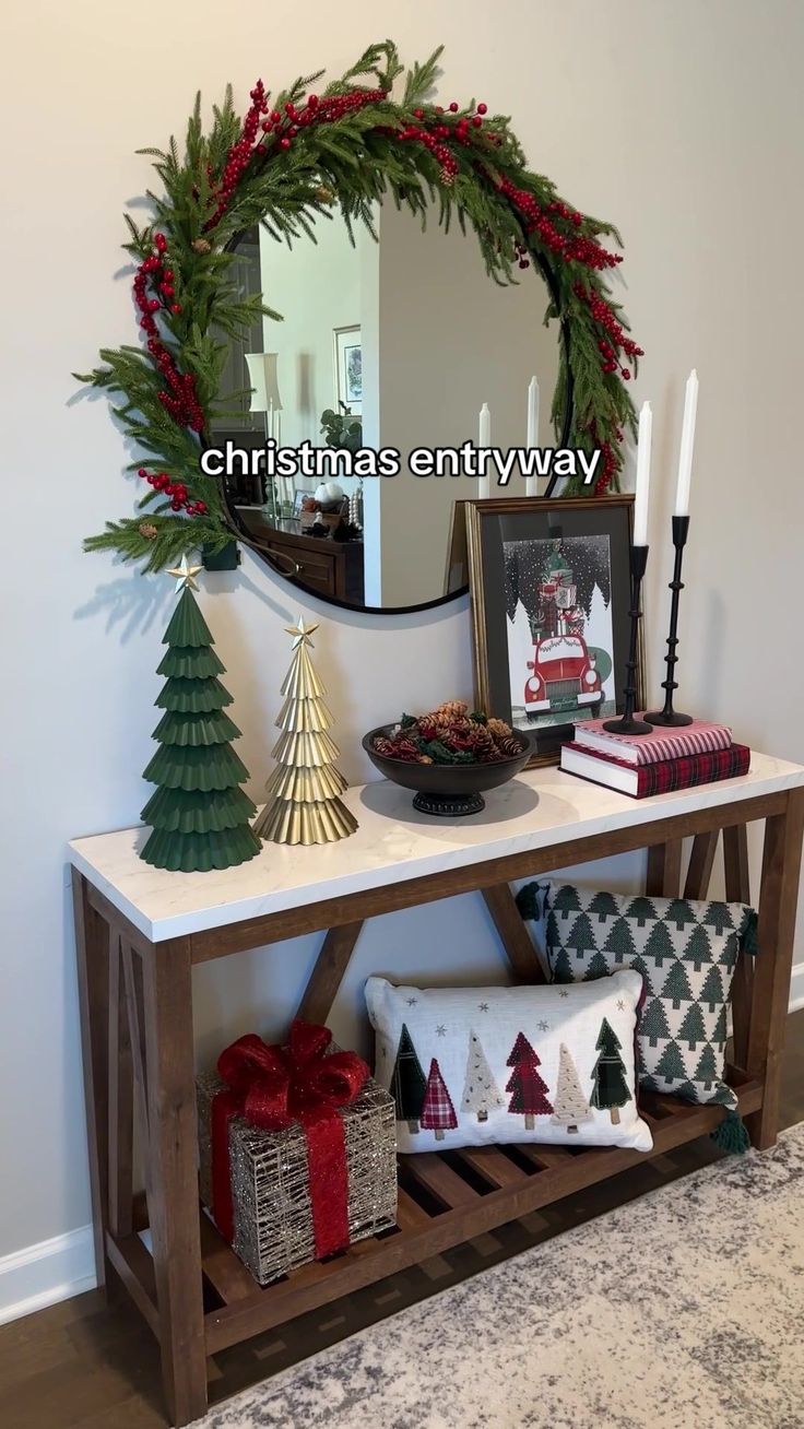 a table with christmas decorations on it and a mirror in the corner next to it