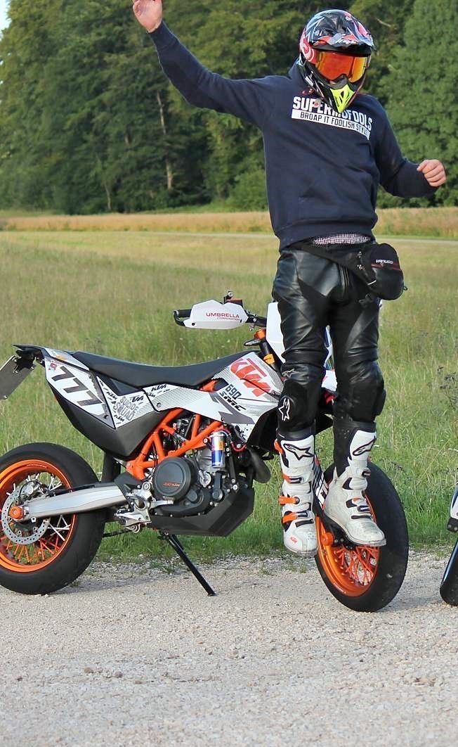 a man standing on top of a dirt bike