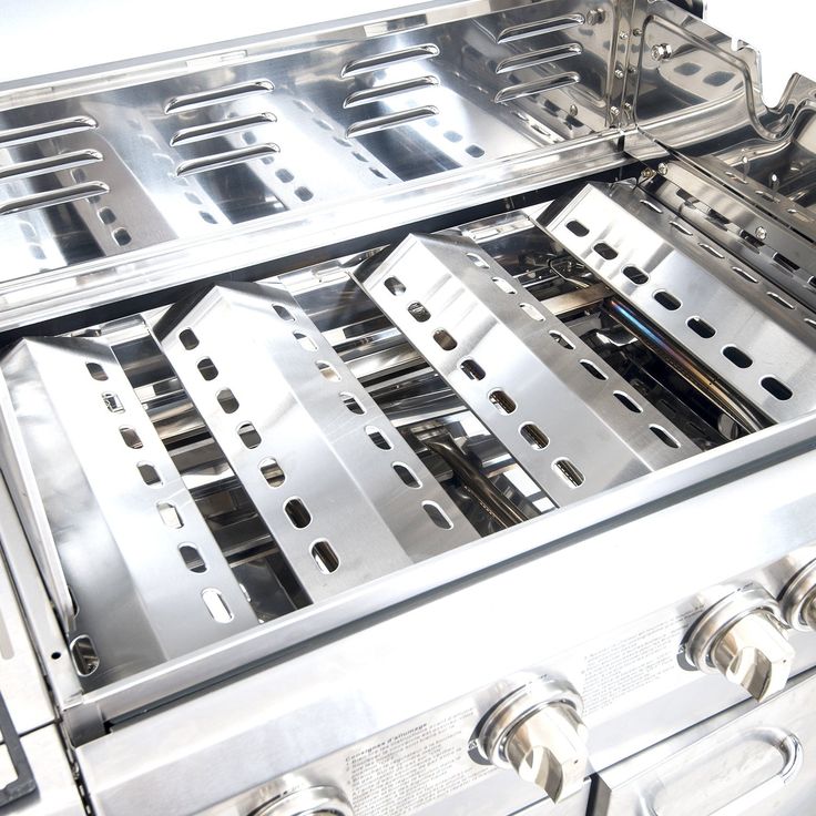 two stainless steel stoves stacked on top of each other with holes in the middle