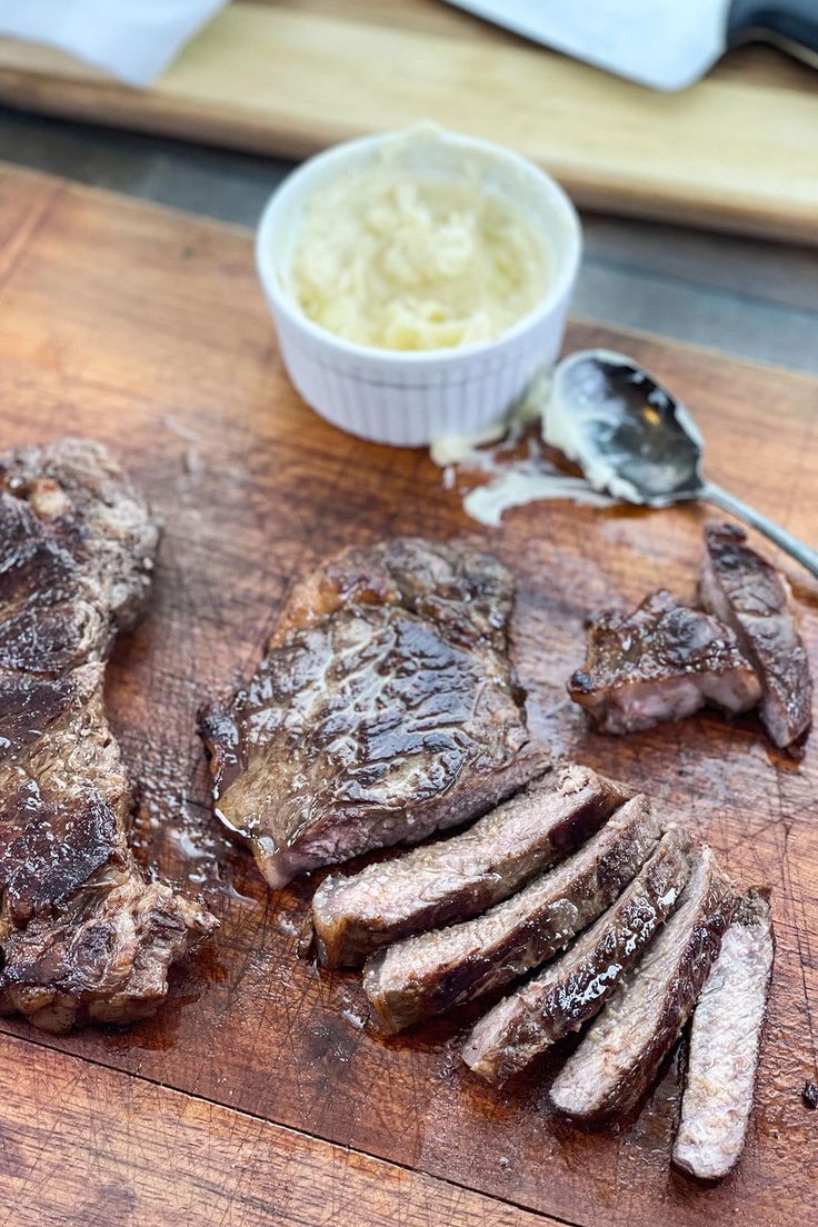 the steak is cut up and ready to be served with mashed potatoes on the side