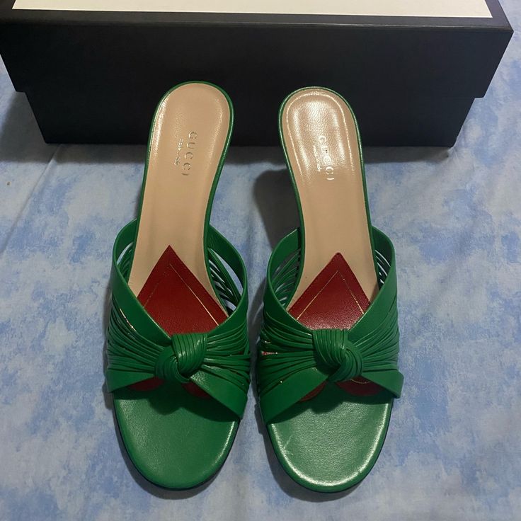 Leather Upper And Sole Made In Italy Approx 75mm/ 3 Inch Heel Knot Accent At Vamp Leather Heart Patch Detail At Midsole Our Style No. Gucc-Wz57 Manufacturer Style No. 577229 Designer Green Formal Sandals, Elegant Green Mules For Evening, Elegant Green Open Heel Mules, Gucci Block Heel Evening Sandals, Gucci Block Heel Sandals For Evening, Gucci Evening Sandals With Block Heel, Chic Gucci Sandals With Block Heel, Gucci Formal Block Heel Sandals, Designer Low Heel Mules With Padded Heel