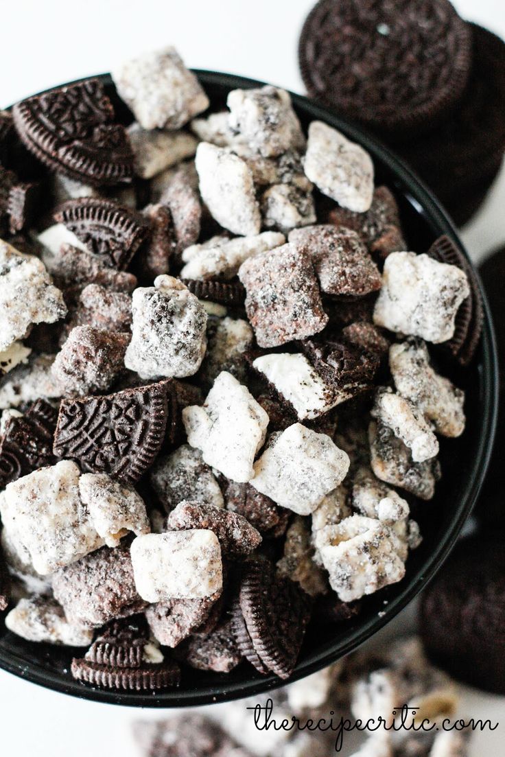 a bowl filled with oreo cookies and marshmallows on top of a table