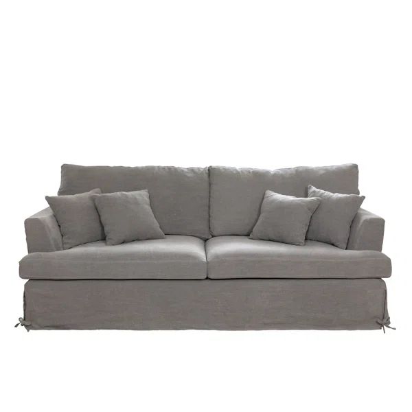 a gray couch with several pillows on it