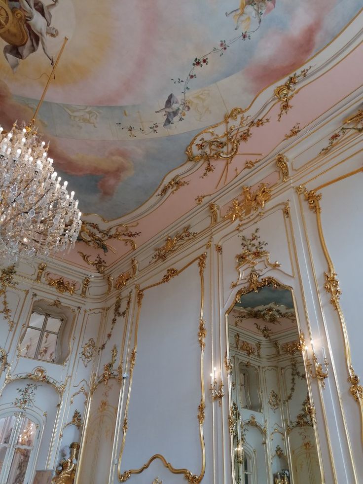 an ornate room with chandeliers and paintings on the ceiling