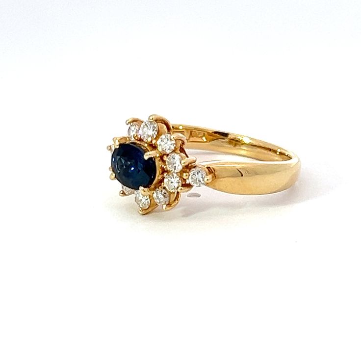 This estate piece features an 18k yellow gold setting that's crafted in the traditional Princess Diana style. The centerpiece is a stunning oval sapphire, surrounded by dazzling diamonds that make this piece truly shine. A perfect addition to any jewelry collection. Jewelry Style : RingMetal Type : 18K Yellow Gold Sapphire : 1 Oval approximately 0.95 CtDiamonds : 12 round, approximately 0.44 ctDiamond Weight : Approximately 0.67 ctwColor : G-HClarity : VS2-SI1Approximate Weight : 4.85 gramsStamp Yellow Gold Cluster Sapphire Ring With Brilliant Cut, Yellow Gold Sapphire Cluster Ring With Brilliant Cut, Cluster Yellow Gold Sapphire Ring, Yellow Gold Cluster Sapphire Ring, Cluster Sapphire Ring In Yellow Gold, Yellow Gold Sapphire Cluster Ring, Yellow Gold Cluster Sapphire Ring With Center Stone, Yellow Gold Sapphire Cluster Ring With Center Stone, Luxury Yellow Gold Sapphire Cluster Ring