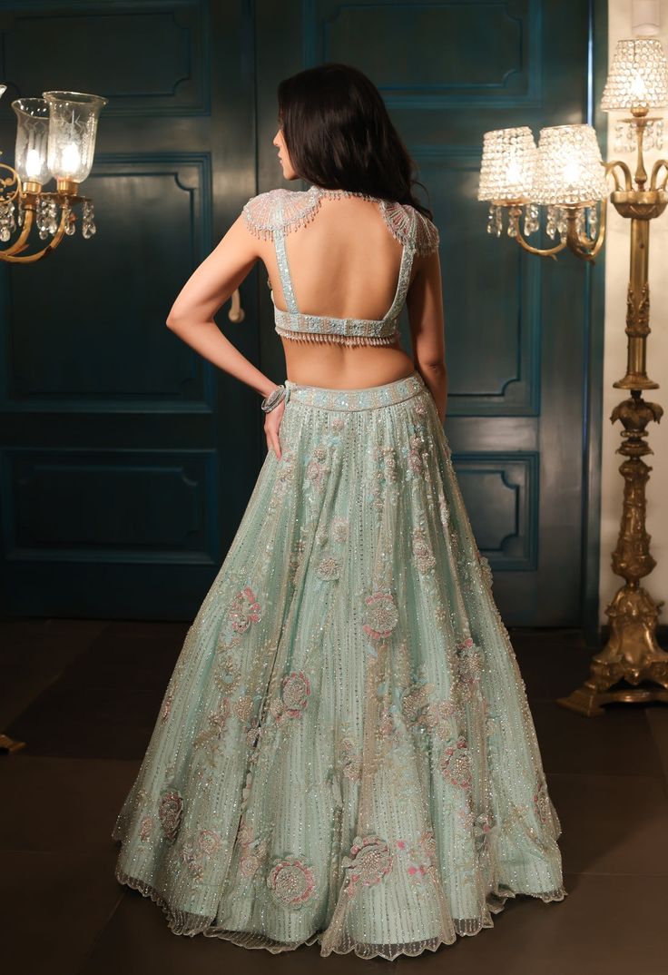 This sea green lehenga features hand embroidered 3D flowers throughout along with sequin,crystal, pearl and cutdana embroidery. It is paired with a matching V neck blouse with tassel and shoulder cap detailing, including an embroidered dupatta.From Isa by Dolly Wahal's Fiori collection.DELIVERY TIMEPlease allow 8-12 weeks for your outfit to arrive.FABRIC DETAILSNetProfessional cleaning only. Pista Green Lehenga With Intricate Embroidery For Party, Green Organza Lehenga With Sequins, Green Embellished Party Wear Choli, Embellished Green Organza Lehenga, Designer Embellished Green Lehenga, Pista Green Embellished Organza Sets, Embellished Pista Green Lehenga For Party, Pista Green Embellished Lehenga For Party, Party Embellished Pista Green Lehenga