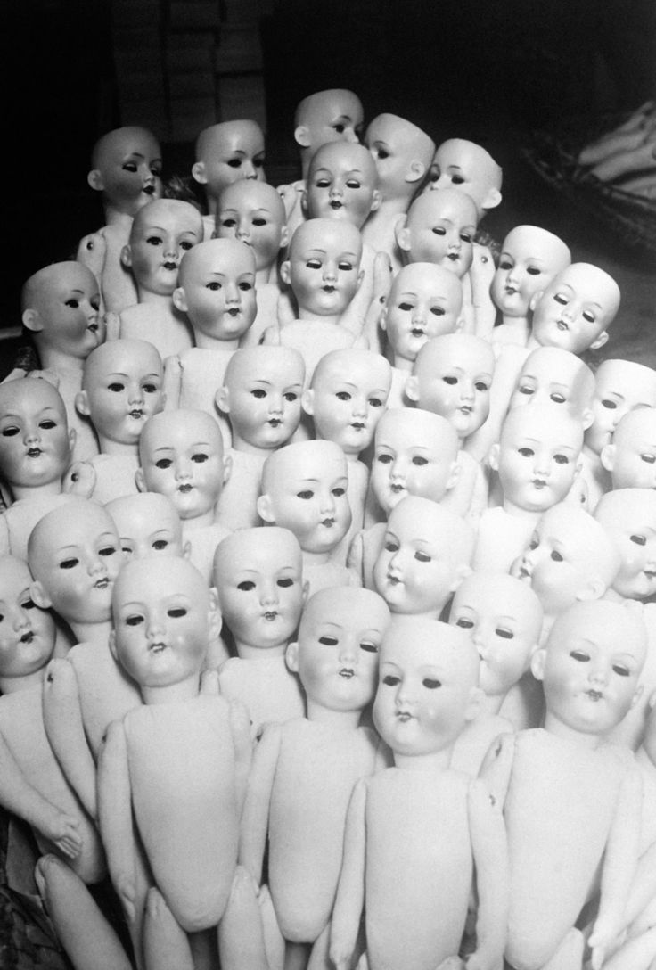 a large group of dolls sitting on top of each other