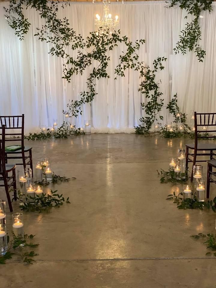 an indoor ceremony with candles and greenery