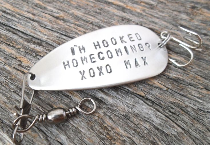 a fishing lure with the words i'm hooked homecombing xoxo max on it