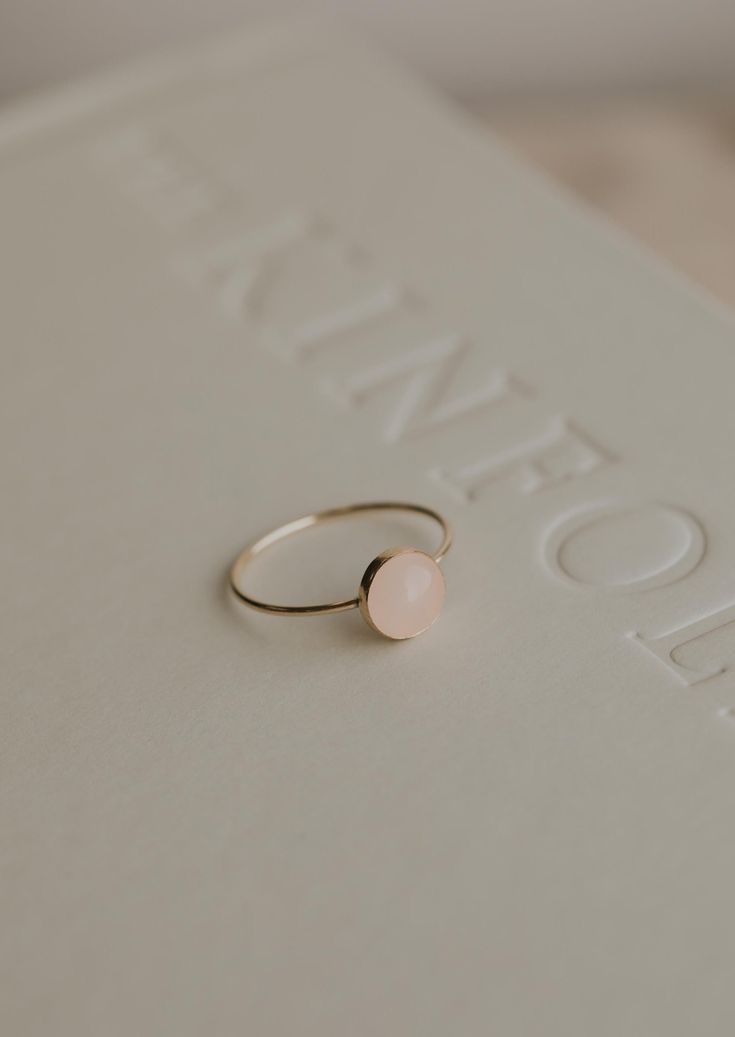 Our Rosie ring is made with a stunning Rose Quartz stone. Known as the crystal of unconditional love, it's said to boost feelings of self-love and foster loving relationships with others. It’s a crystal connected to the heart chakra which colors our life with compassion, love and beauty. 8mm round or 5x7mm oval rose quartz stone. Ring band measures 1mm wide. Available in 14kt Gold Fill + Sterling Silver. Rediet pairs it with our Supermoon Ring and Teeny-Tiny Band. Kayla pairs it with two Confett Confetti Rings, Loving Relationships, Love And Beauty, Everyday Wear Jewelry, Jewelry Photoshoot, Heart Shaped Jewelry, Rose Quartz Stone, Rose Quartz Gemstone, Love Ring