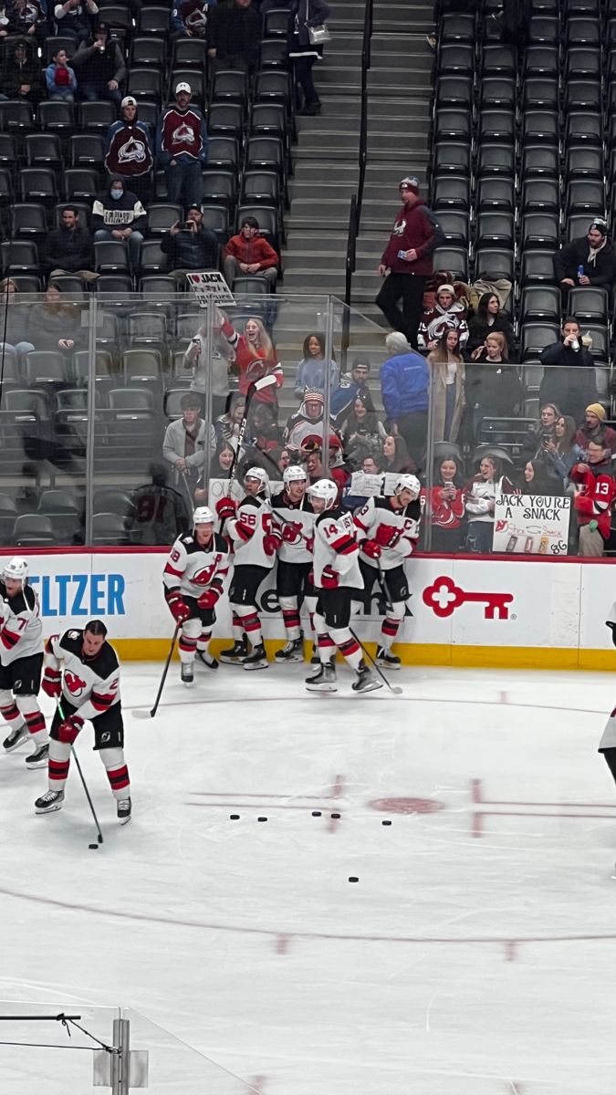 the hockey team is playing on the ice in front of an empty stadium full of people