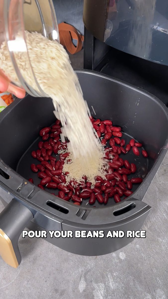 a person pours red beans and rice into a blender