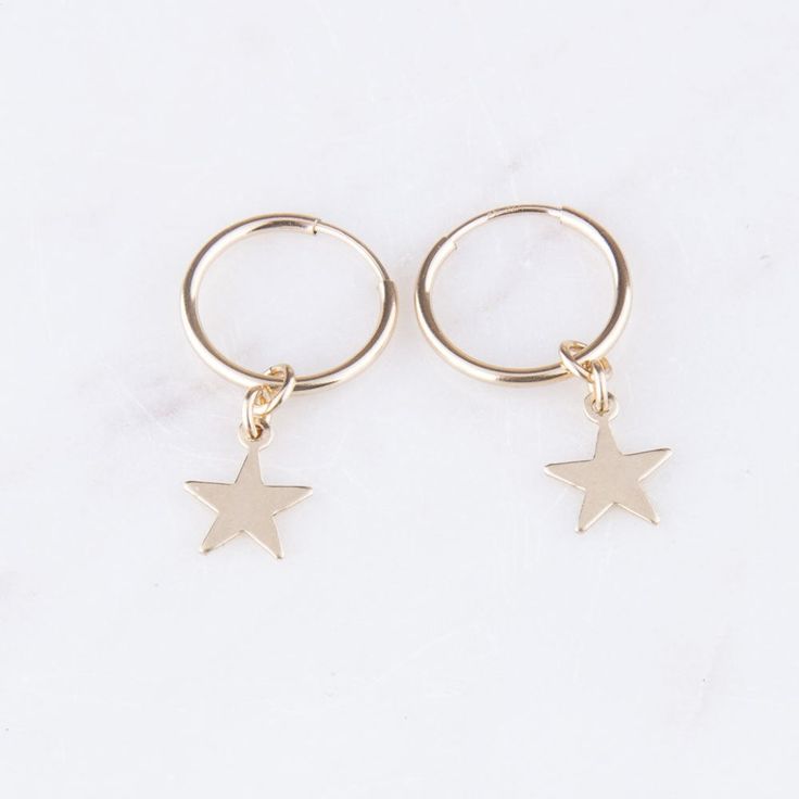 Star Dangle Hoop Earrings in 14K Gold Filled. You will LOVE these hoop earrings. They are lightweight and so adorable! Each hoop earring is paired with a star to give you a simple and stylish look to your wardrobe. EARRING DESCRIPTION: - 14K gold filled endless hoops(available in 14mm, 16mm, 20mm and 24mm) - 14K gold filled 7mm star dangle - Measures approx. an inch long for 14mm including with star - 14mm is pictured, 24mm = 1 inch - Handmade and packaged beautifully for you! More Earrings: htt Star-shaped Earrings With Dangling Charms As Gift, Star-shaped Earrings With Dangling Charms For Gift, Minimalist Star-shaped Cartilage Earrings With Star Charm, Star-shaped Hoop Earrings With Dangling Charms For Gift, Star Shaped Hoop Earrings With Dangling Charms For Gift, Star-shaped Hoop Earrings With Dangling Charms, Absolute Zero, Gold Star Earrings, Celestial Earrings