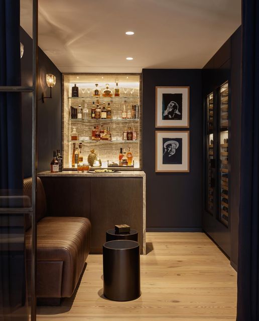 a bar with bottles on the shelves and stools