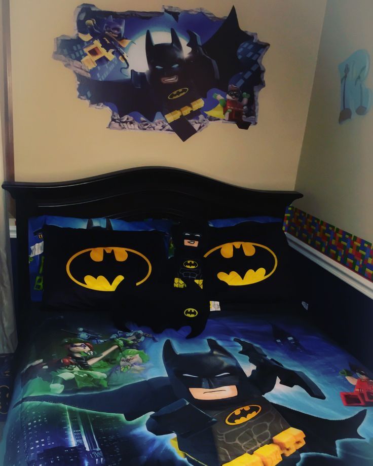 a batman themed bed in a bedroom