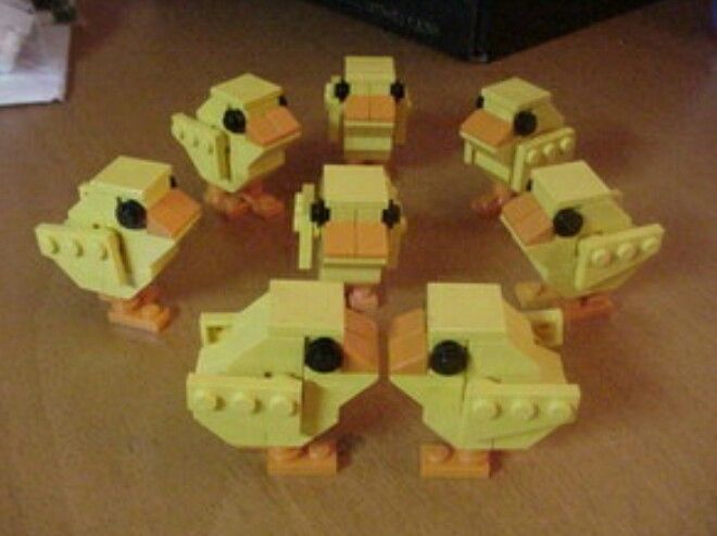 a group of yellow legos sitting on top of a wooden table