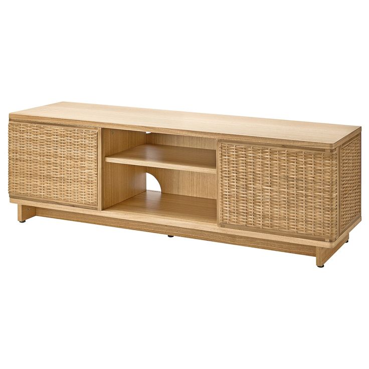 a wooden entertainment center with wicker doors and shelves on one side, in front of a white background