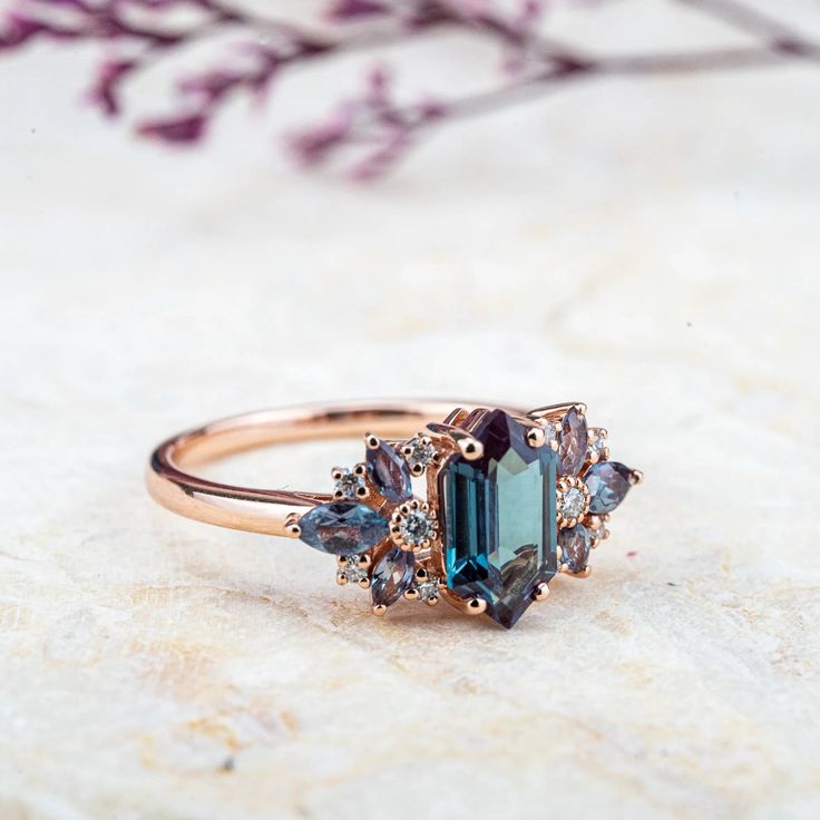 a close up of a ring on a table with flowers in the background and a plant behind it