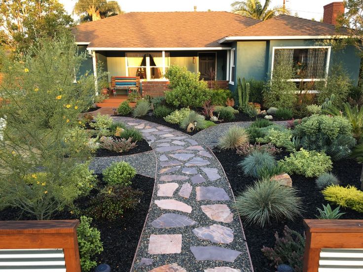 a house with a stone pathway leading to the front door