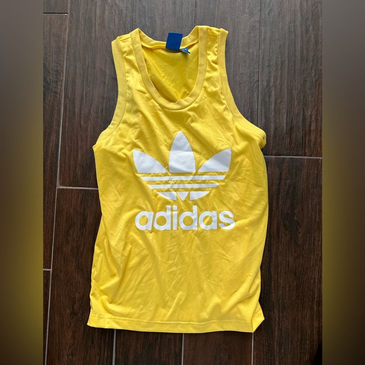 Adidas Cut Off T Shirt Bright Yellow With Adidas Logo Size Small- Good Condition Yellow Sports Tank Top For Summer, Yellow Summer Sports Tank Top, Yellow Tank Top For Summer Sports, Adidas Casual Tank Top For Sports, Yellow Sleeveless Cotton T-shirt, Casual Yellow Tank Top With Graphic Print, Adidas Tank Top For Summer Sports, Adidas Sporty Summer Tank Top, Sporty Yellow Tops With Graphic Print