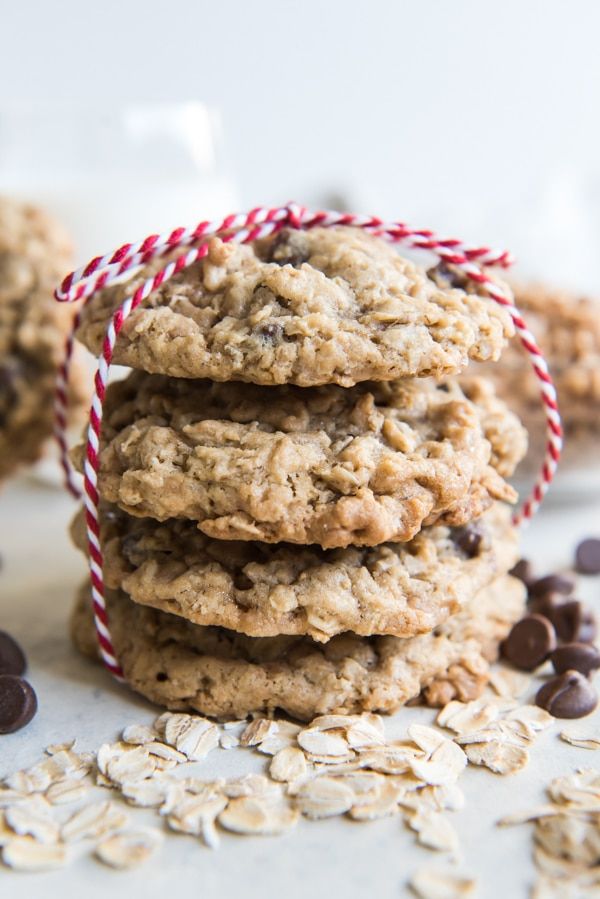 chocolate chip oatmeal cookies stacked on top of each other with candy cane